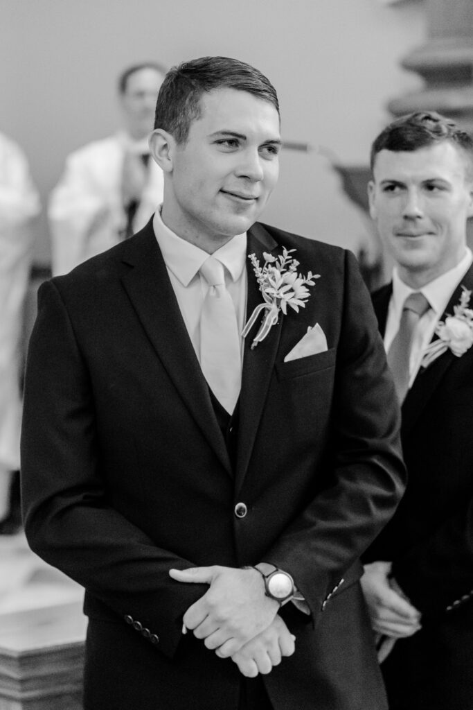 A groom looking lovingly at his bride