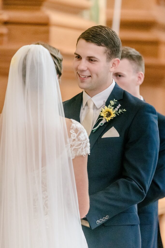 A groom looking lovingly at his bride during their wedding ceremony