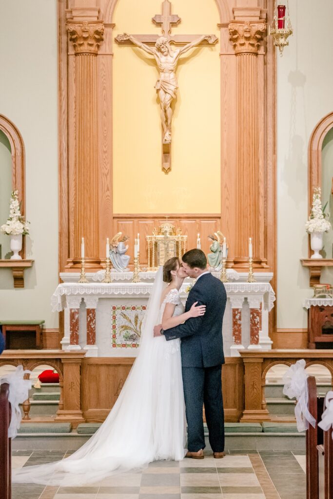 A bride and groom share their first kiss as husband and wife