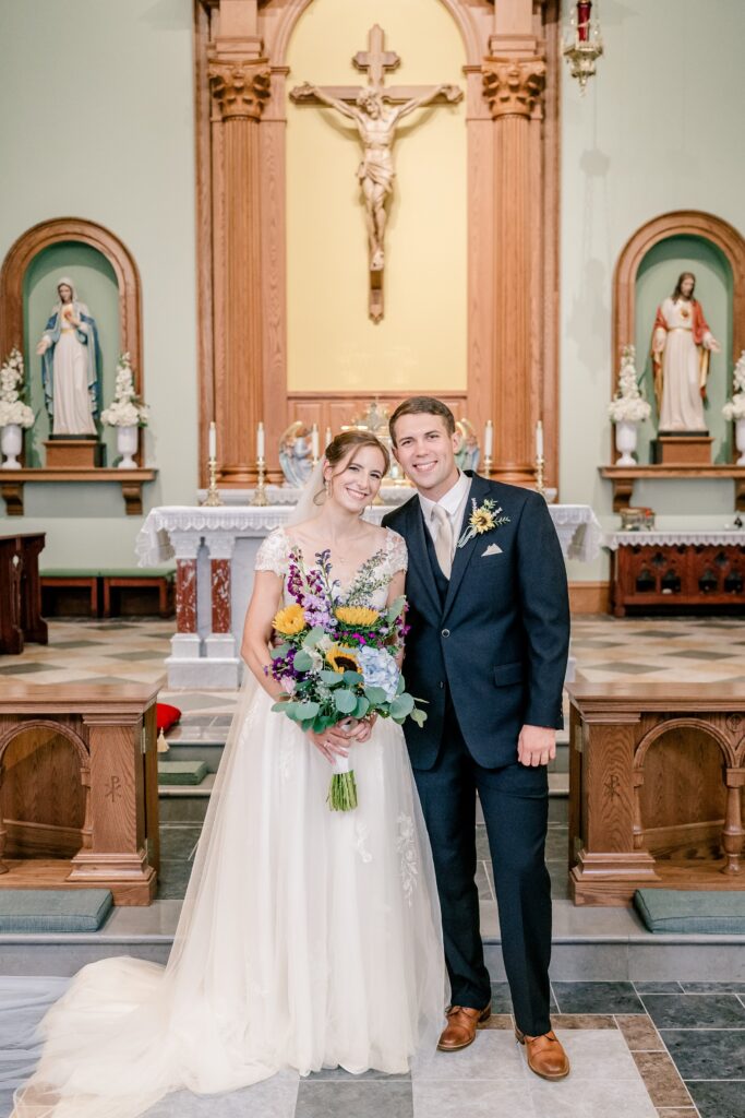 A bride and groom smiling after their wedding at St. Patrick Catholic Church in Fredericksburg, VA