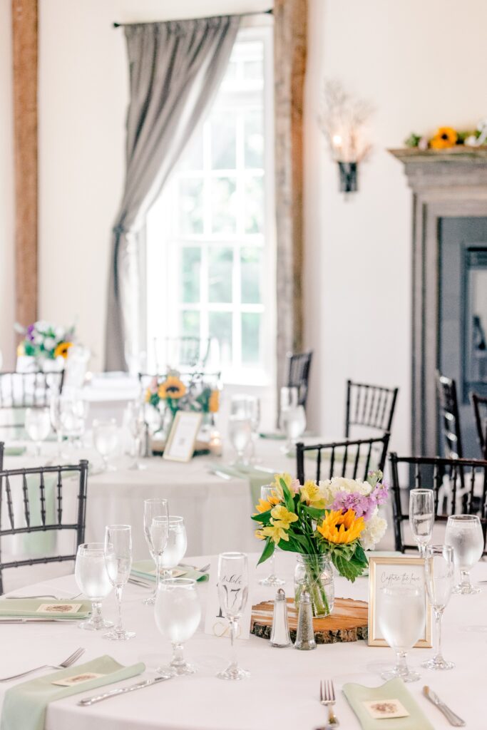 A detail photo of summer flowers on dining tables for a Stevenson Ridge wedding reception