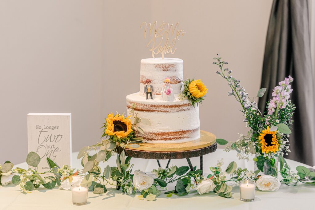 A naked wedding cake with sunflower decor