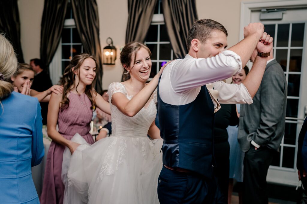 A bride and groom dancing with guests during their Stevenson Ridge wedding reception