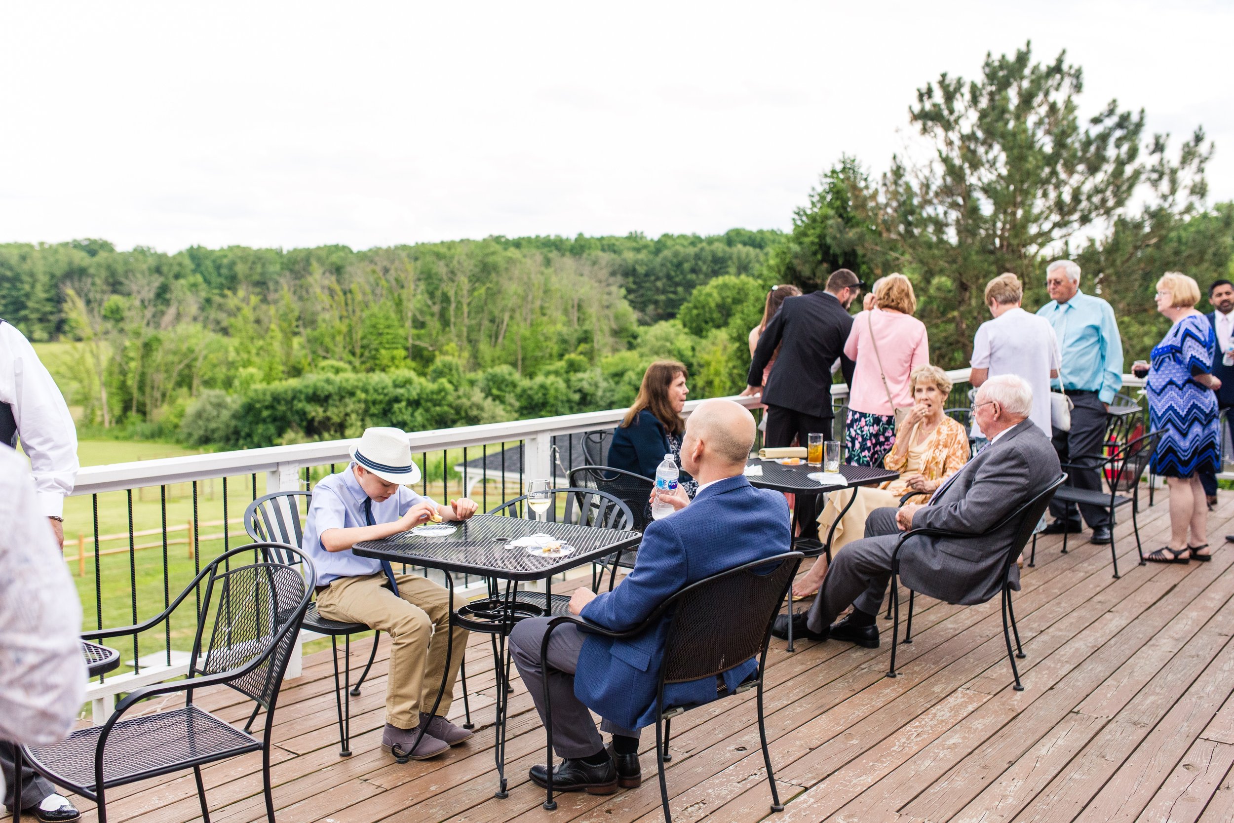 Guests enjoying cocktail hour on the patio during a wedding at The Best Wedding Venue in Loudoun County