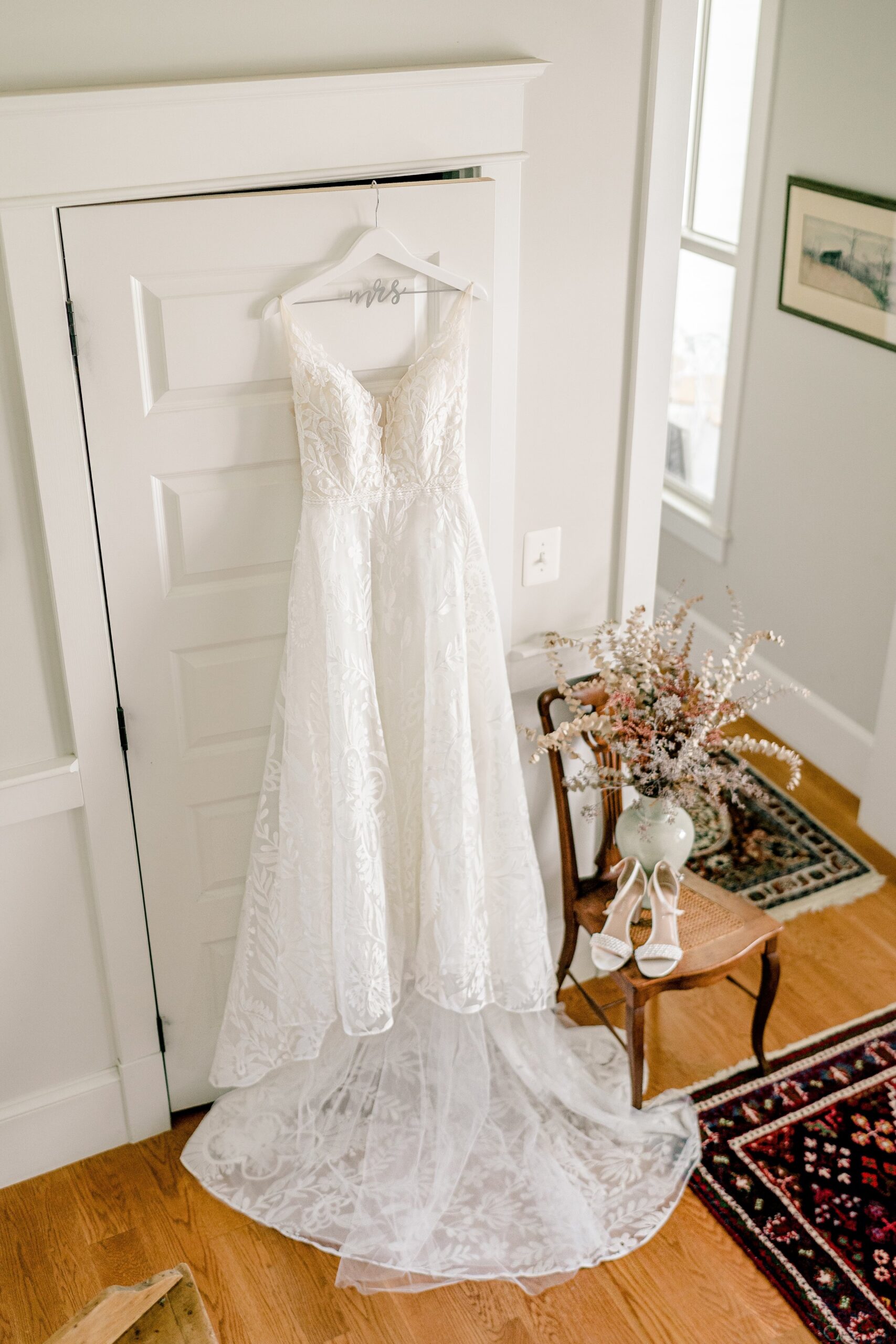 A wedding dress hanging from a closet door inside a farm house at one of the best wedding venues in Loudoun County Virginia