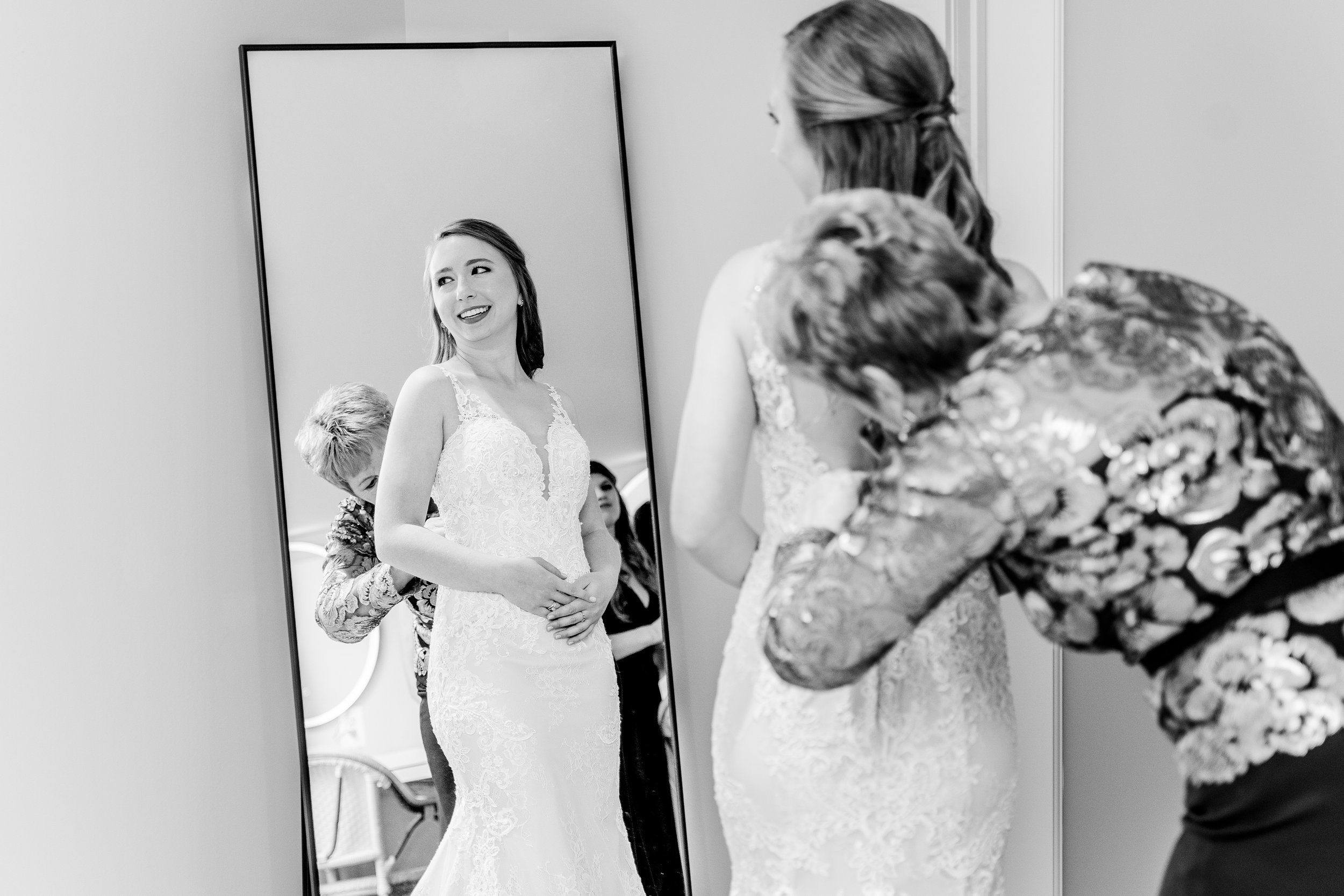A bride looking in the mirror while getting ready for her wedding at Fleetwood Farm Winery in Loudoun County Virginia