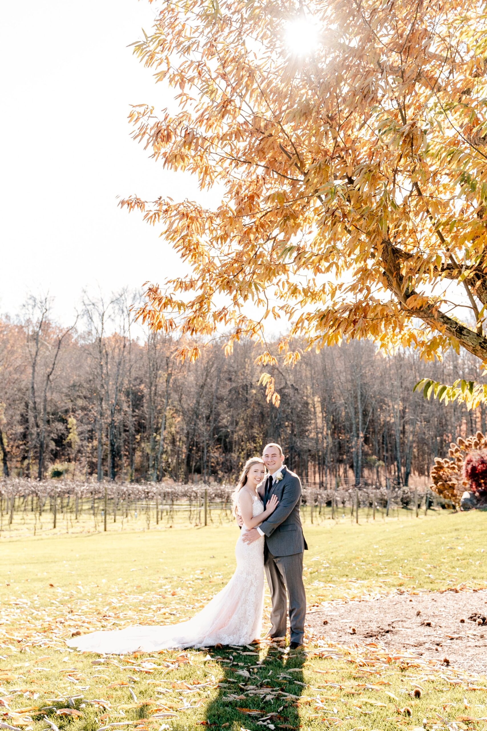 A bride and groom pose for a classic portrait in front of the vineyard during their wedding at Fleetwood Farm Winery in Loudoun County, Virginia