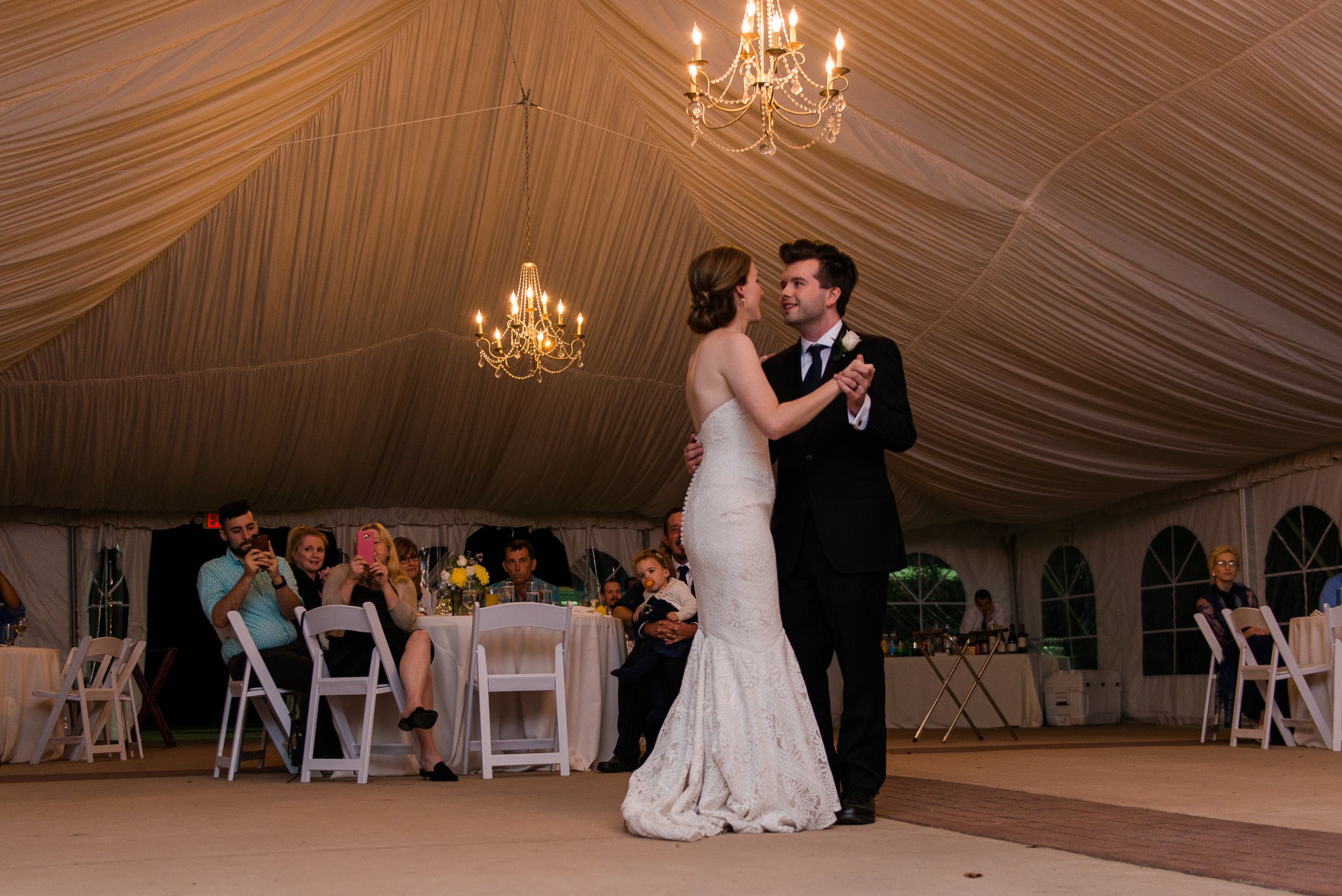 A bride and groom share their first dance during their tented wedding reception at Oatlands Historic House and Gardens in Loudoun County Virginia