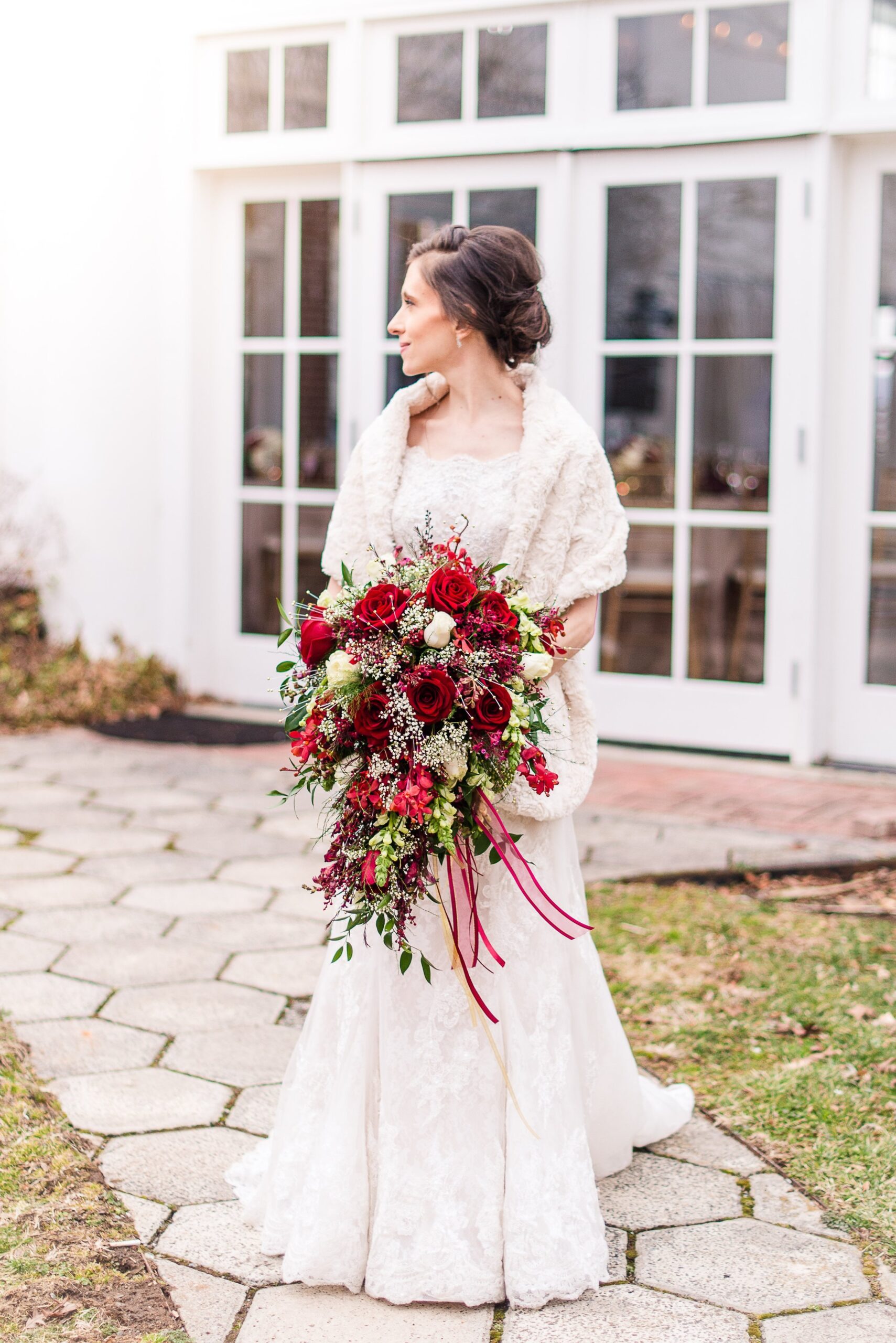 A bride looking over her shoulder outside before her wedding at Raspberry Plain Manor in Leesburg Virginia