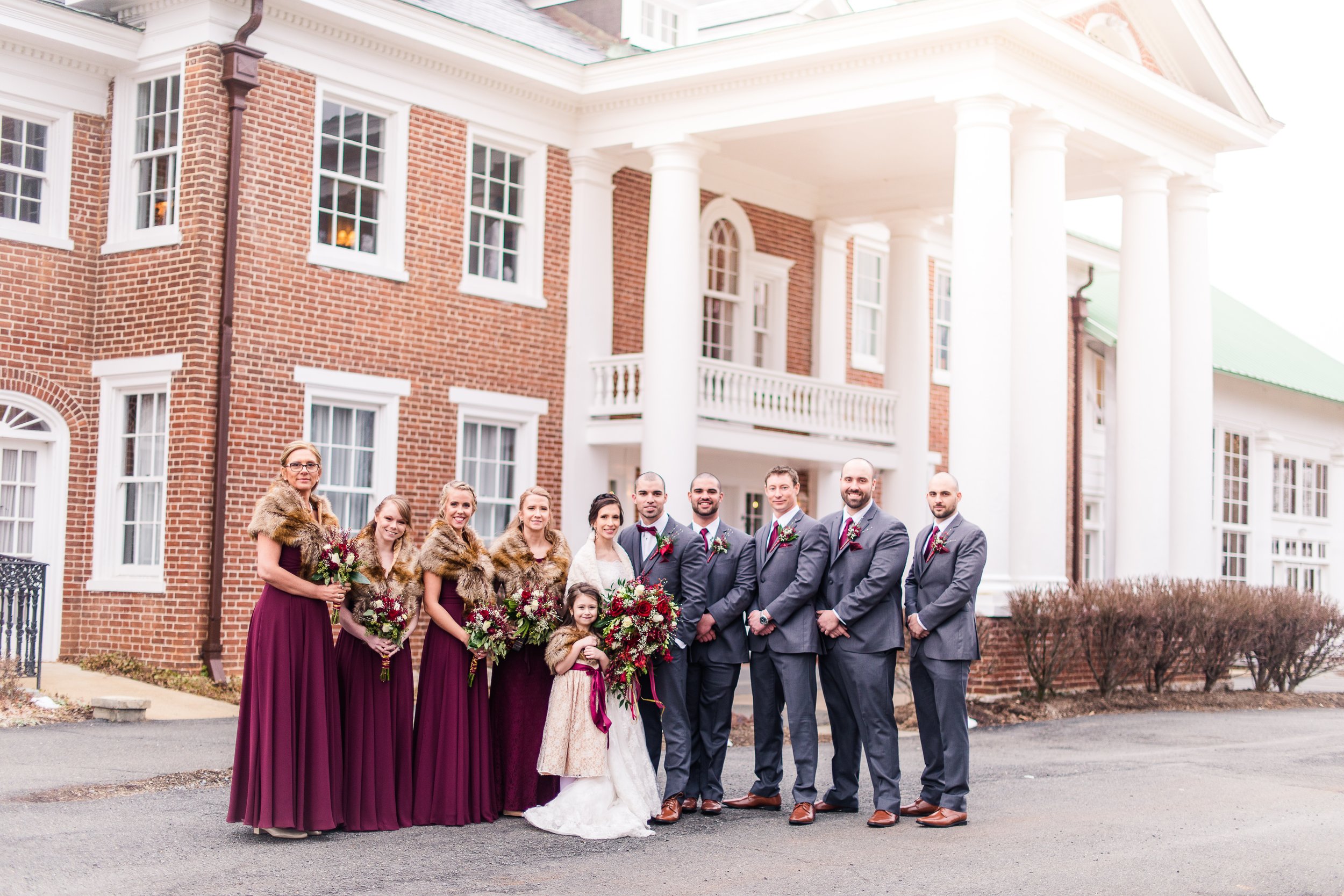 A bridal party posed in front of one of the best wedding venues in Northern Virginia