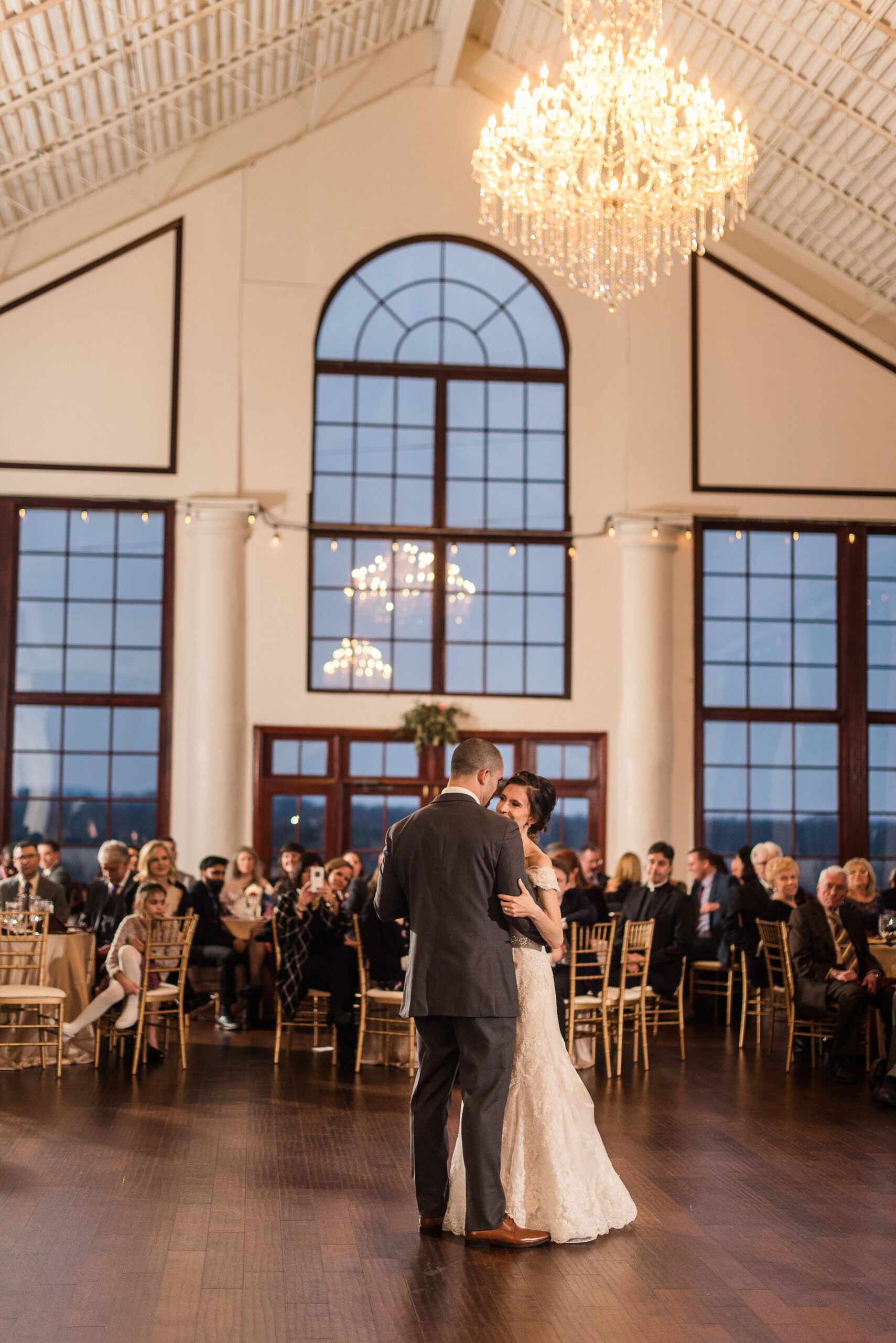 A bride and groom share their first dance during their ballroom wedding at Raspberry Plain Manor in Loudoun County Virginia
