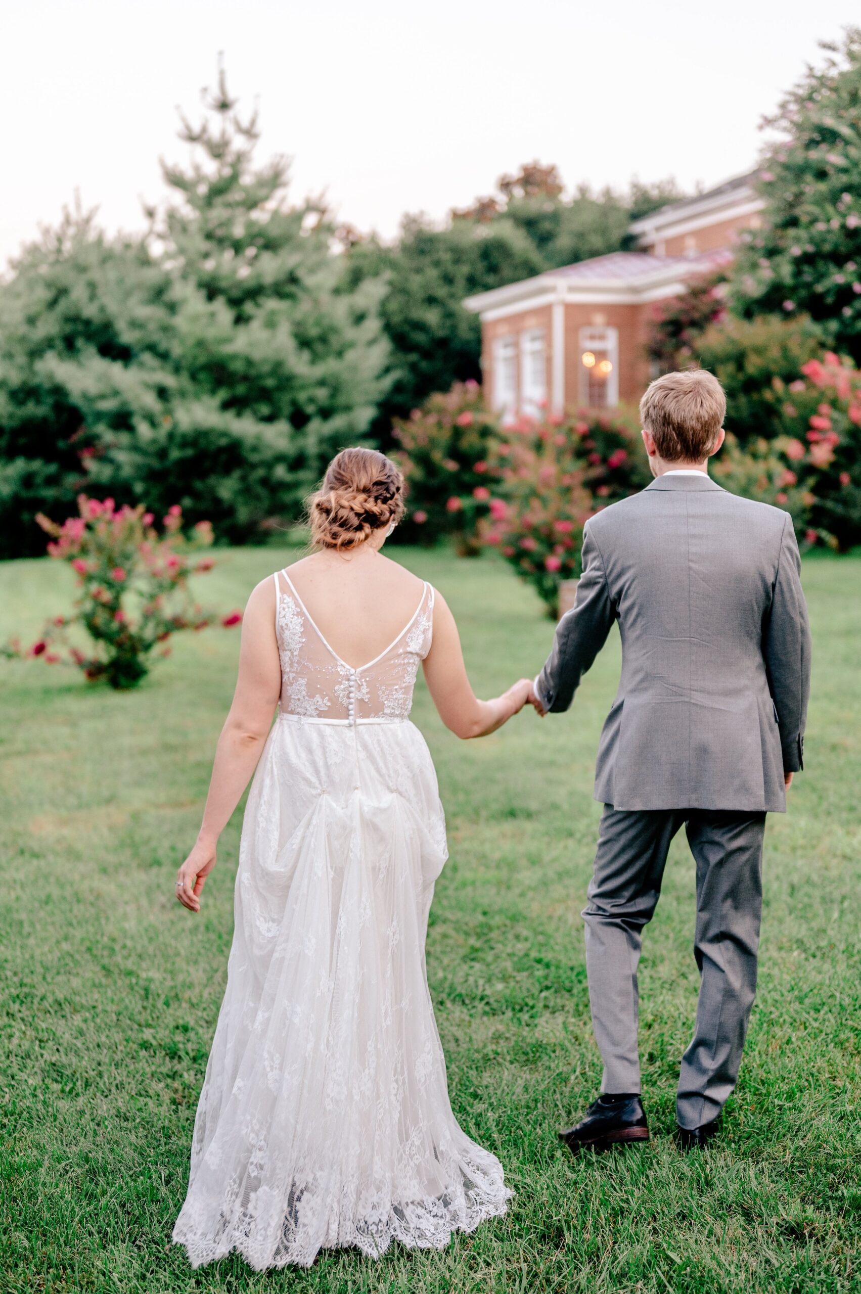 A bride and groom walking together through the gardens at one of the best wedding venues in Northern Virginia