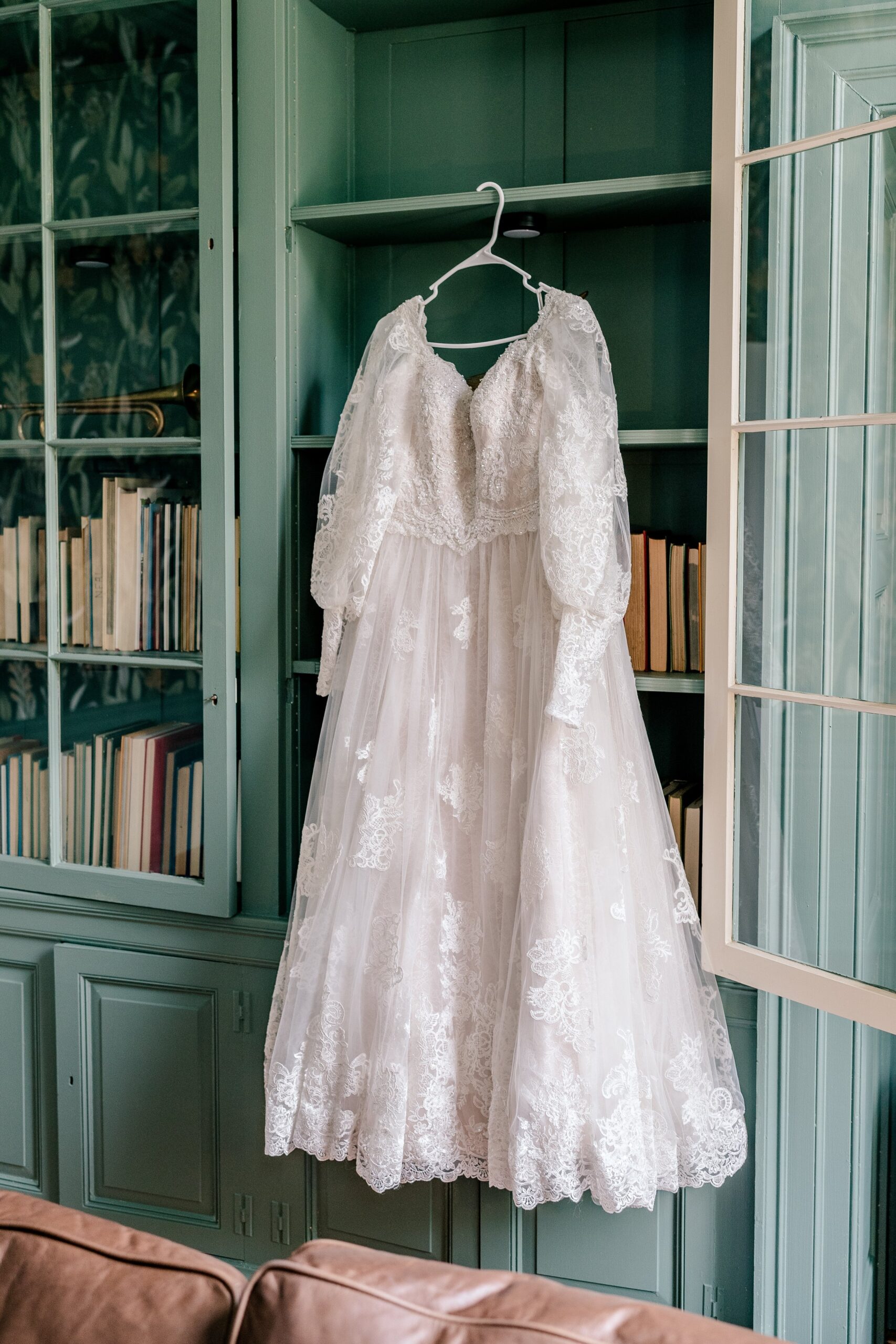 A dress hanging in the library at one of the best wedding venues in Loudoun County Virginia