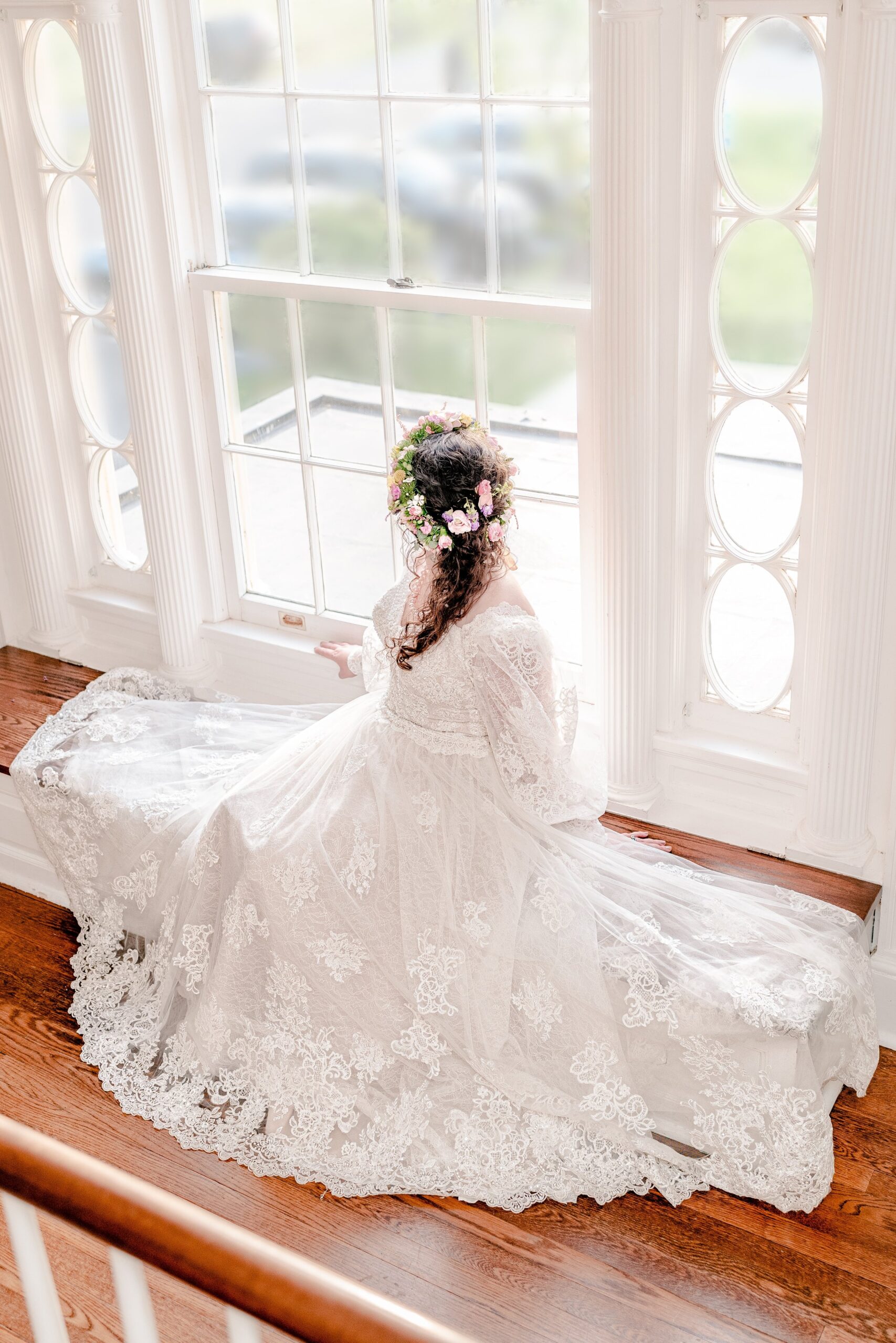 A bride gazing out the window of one of the best wedding venues in Northern Virginia