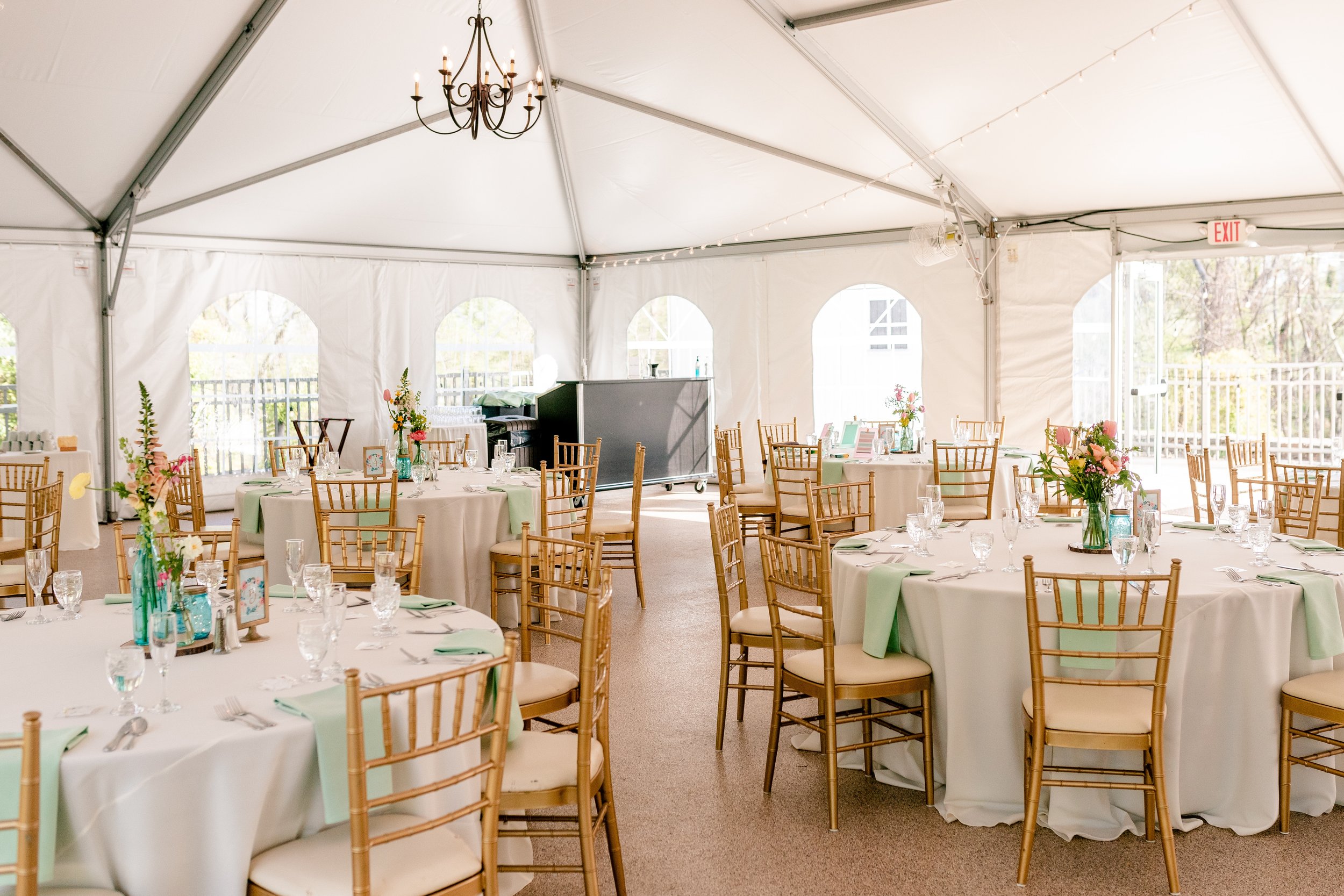 Tables set with colorful decor for a tented wedding at Rust Manor House in Loudoun County Virginia