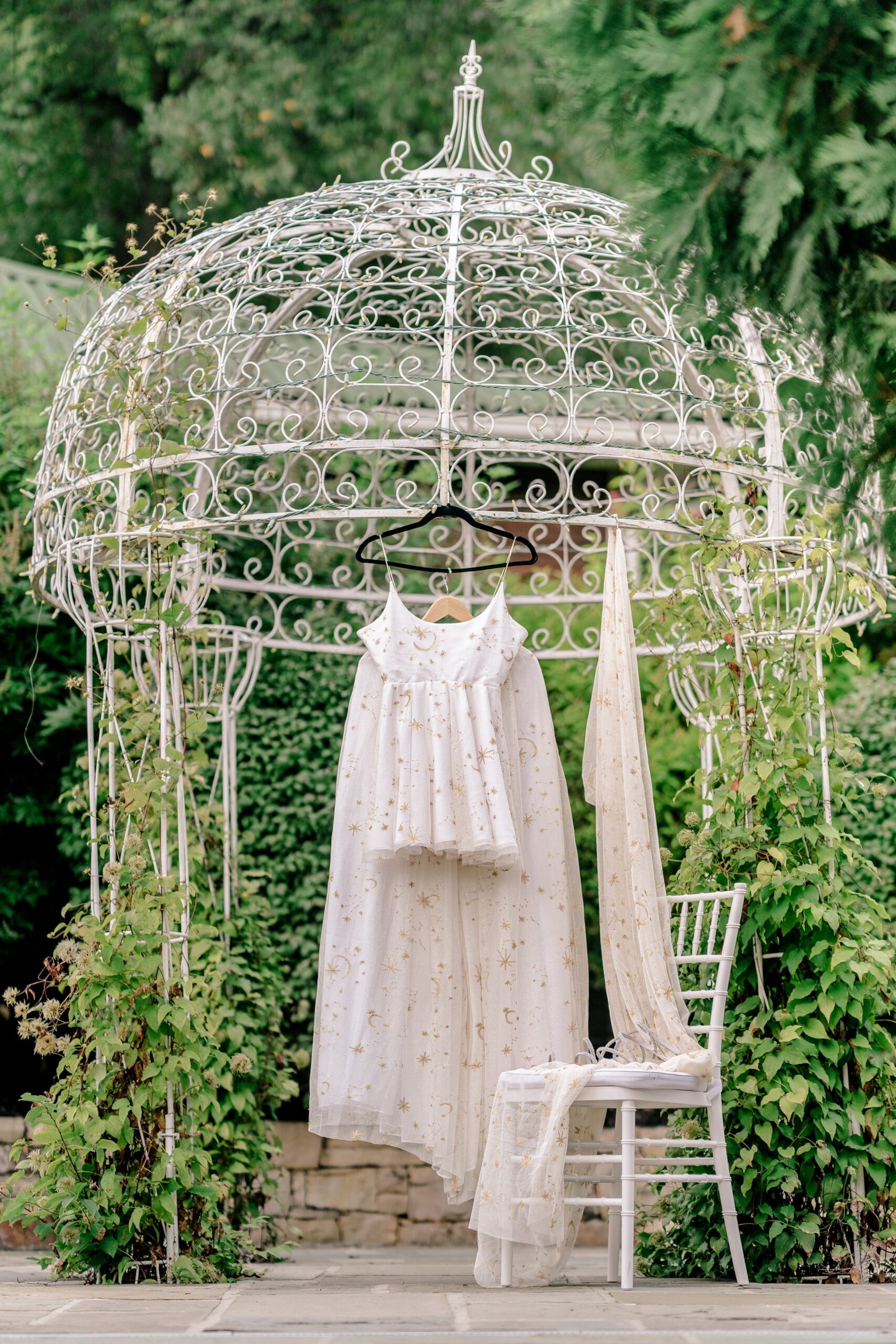 A celestial wedding dress hanging outdoors for a wedding at Stone Manor Boutique Inn in Lovettsville, Virginia