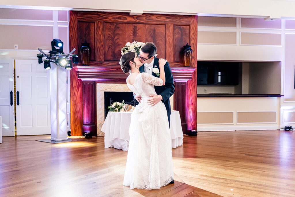 A bride and groom sharing a kiss in the ballroom for their wedding at The Country Club of Fairfax in Northern Virginia