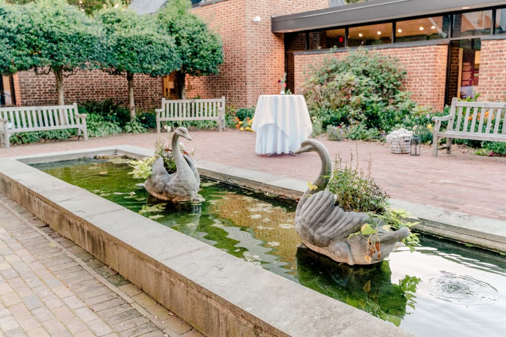 A water feature that includes stone swans in the courtyard for a wedding at one of the best wedding venues in Northern Virginia