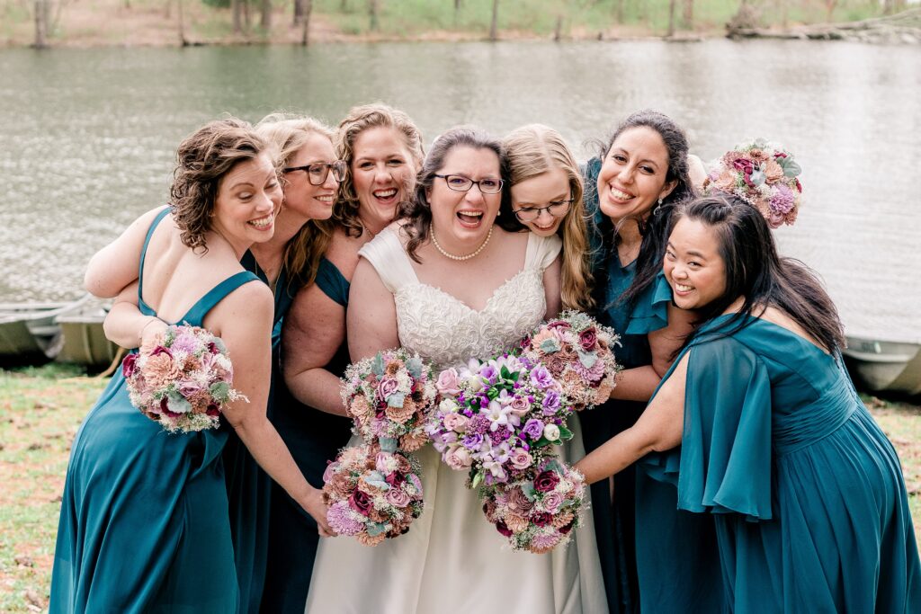 A bridal party gathering for a group hug