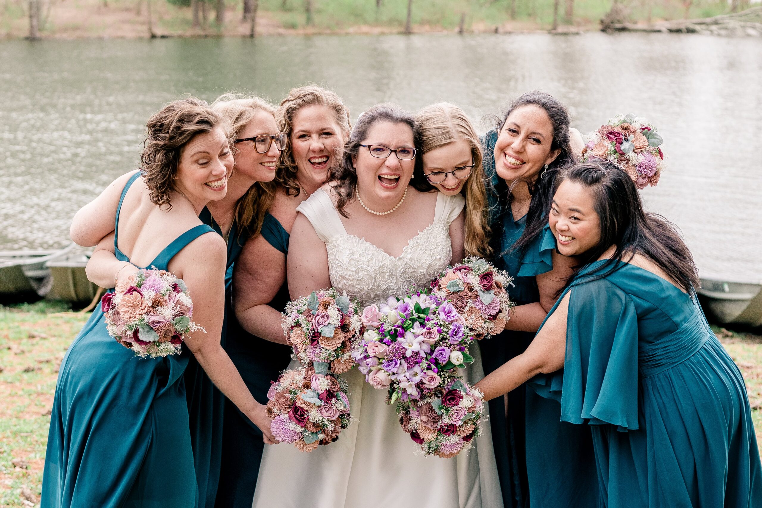 A bridal party shares a group hug around the bride during a Catholic wedding in Towson MD