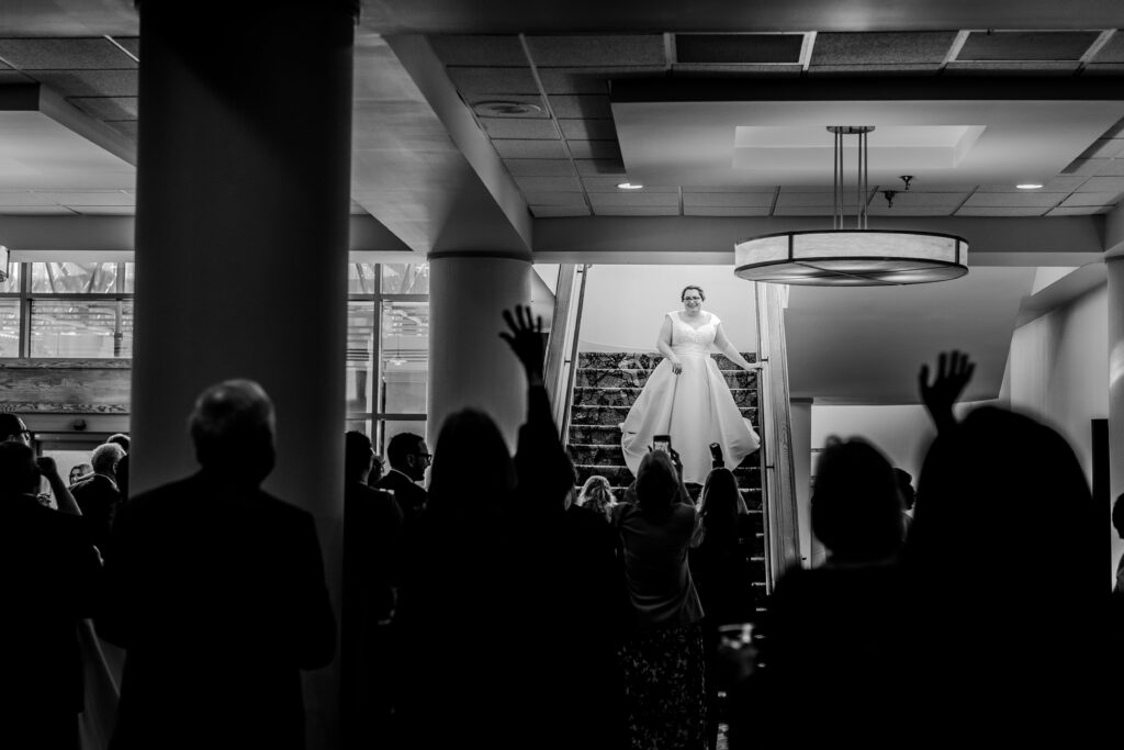 A bride descends the stairs during her wedding reception at the Sheraton Baltimore North