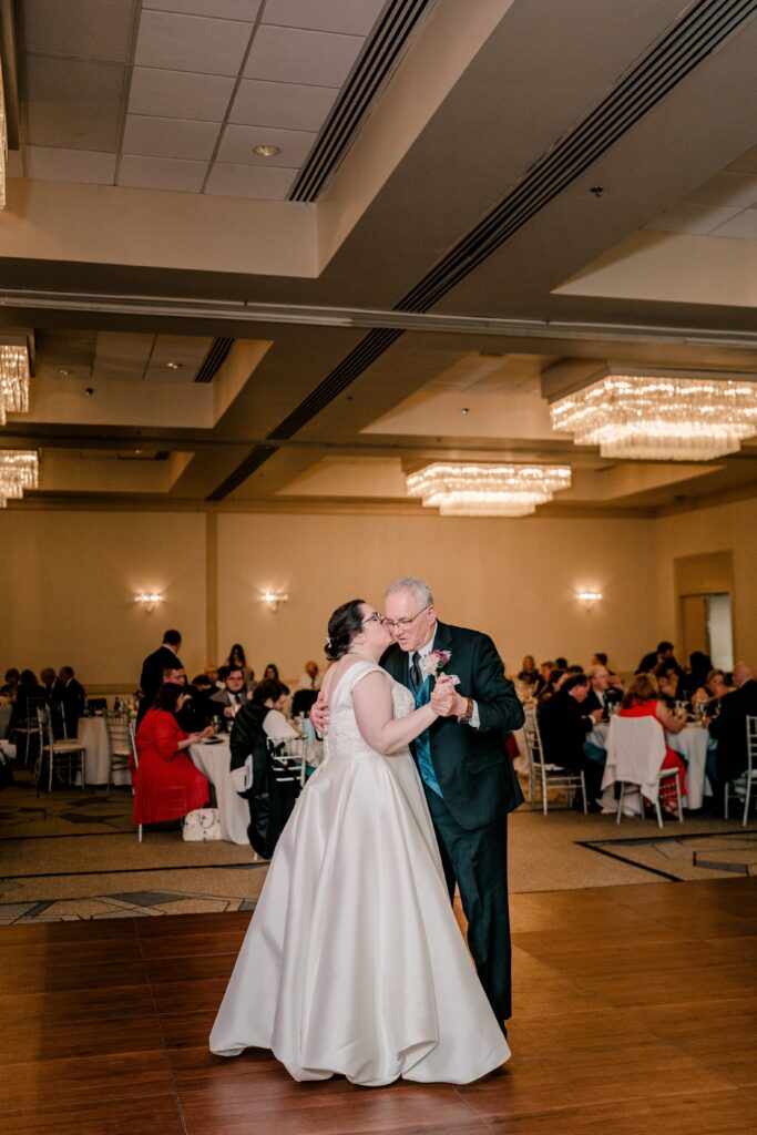A bride and her father share a dance during her Catholic wedding in Maryland