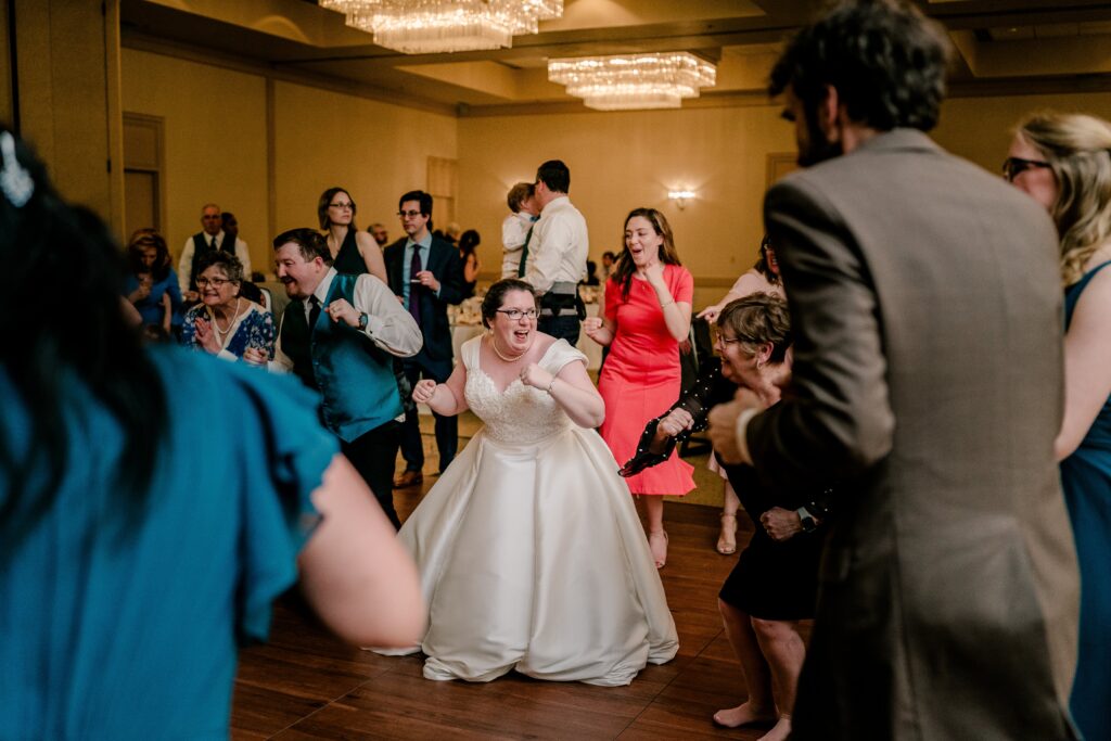 A bride and groom dance with their guests during a Catholic wedding reception at the Sheraton Baltimore North