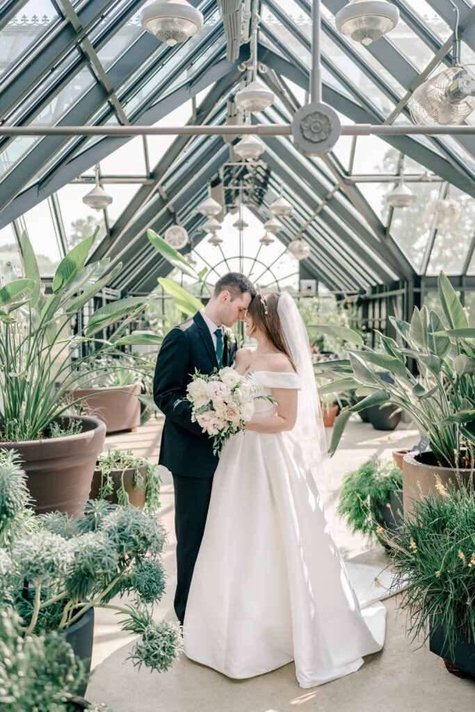 A bride and groom portrait inside the greenhouse at one of the best wedding venues in Northern Virginia