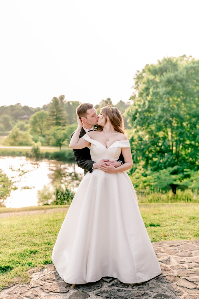A bride and groom share a kiss at golden hour during their wedding at Meadowlark Botanical Gardens