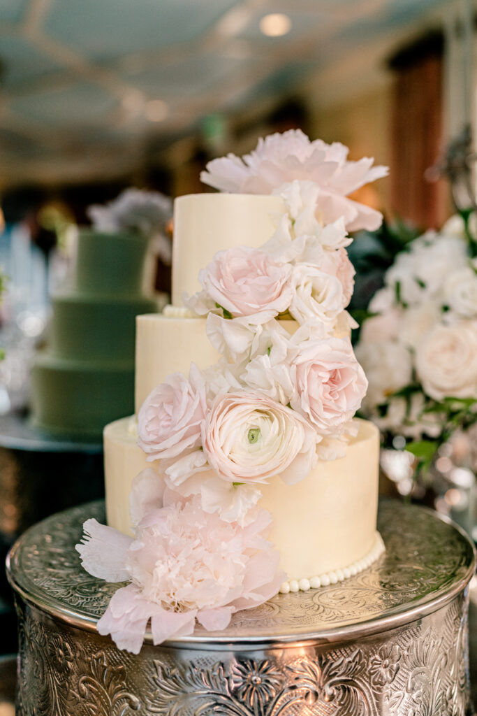 A cascade of blush flowers decorate floral wedding cake inspiration