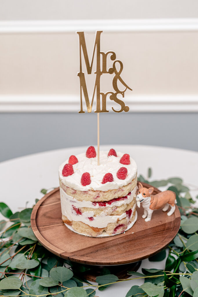A single tier naked cake with raspberry filling