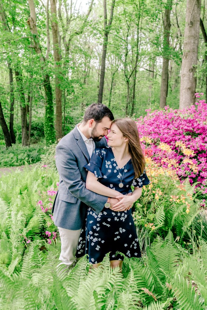 A couple smiles at each other while posed forehead to forehead during their Meadowlark Botanical Gardens engagement session