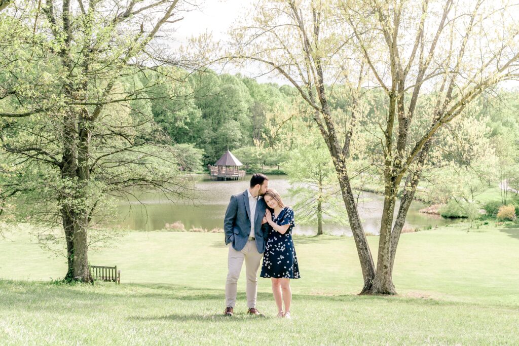 A man kisses his beloved on the top of the head during their Meadowlark Botanical Gardens engagement session