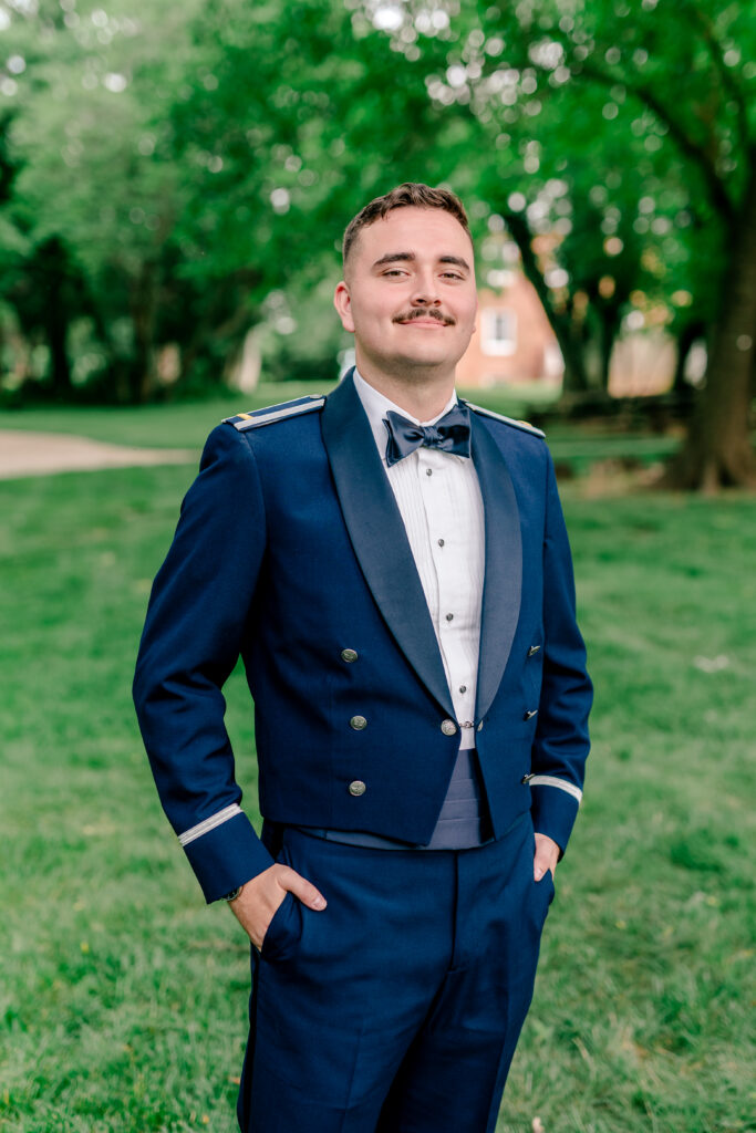 A groom posing for a serious portrait during a tented wedding reception at Historic Blenheim in Fairfax, Virginia