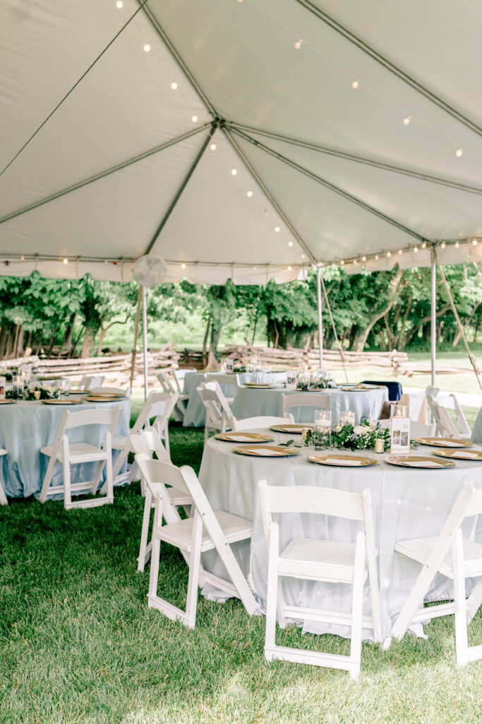 Tables set up under the tent during a tented wedding reception at Historic Blenheim in Fairfax, Virginia