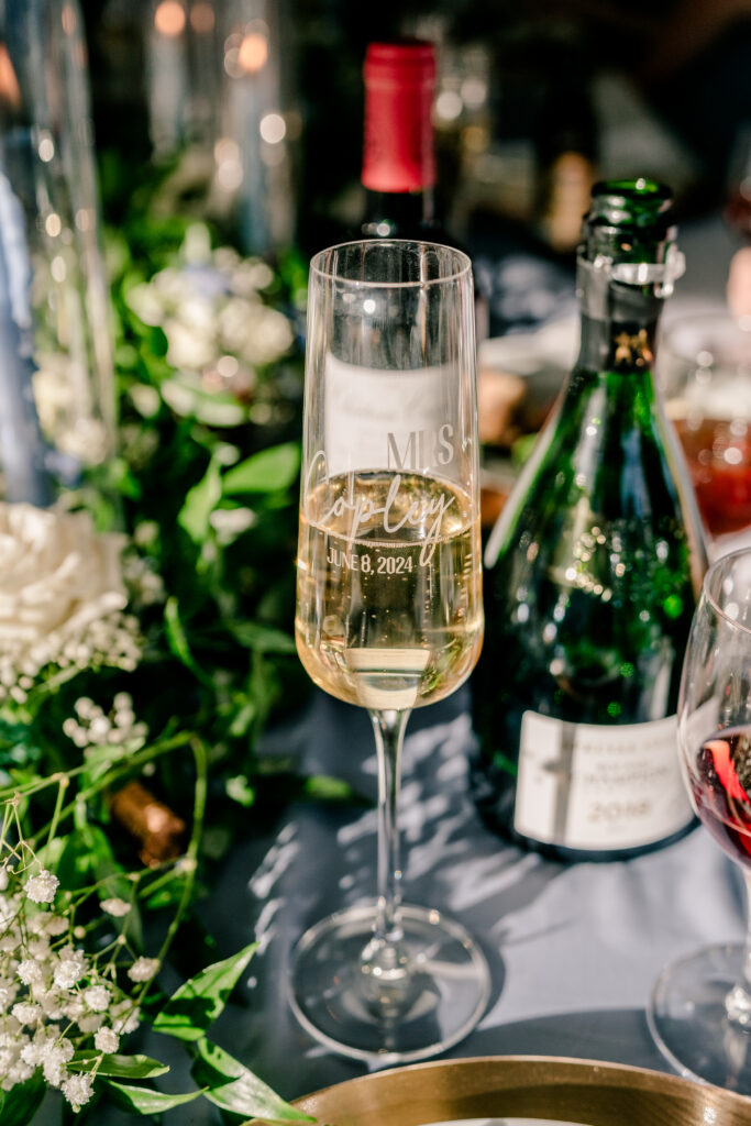 A personalized champagne glass for the bride during a tented wedding reception at Historic Blenheim in Fairfax, Virginia