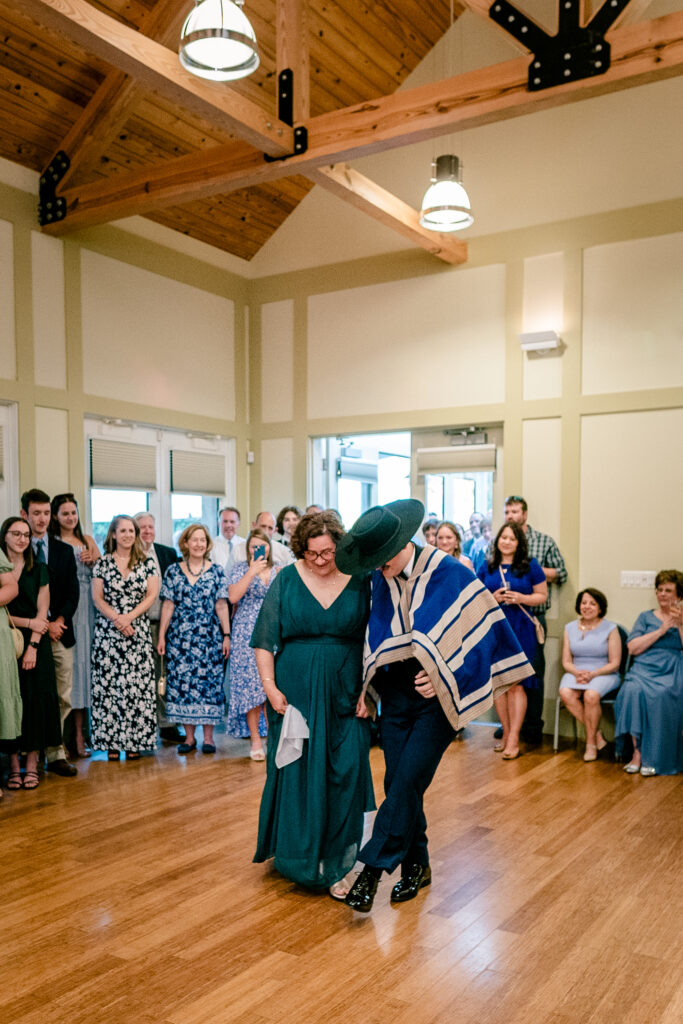 A groom and his mother performing a traditional Chilean dance together during a tented wedding reception at Historic Blenheim in Fairfax, Virginia