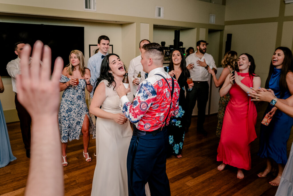 A bride and groom dance together during a tented wedding reception at Historic Blenheim in Fairfax, Virginia