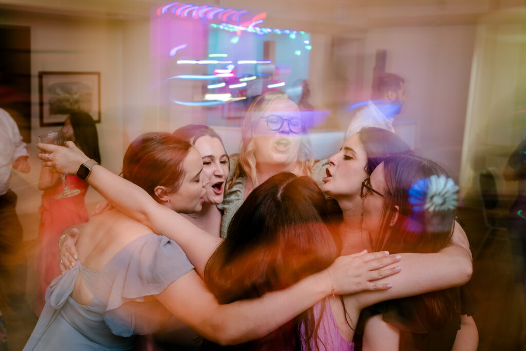 A group of guests dancing with a blur effect applied during a tented wedding reception at Historic Blenheim in Fairfax, Virginia