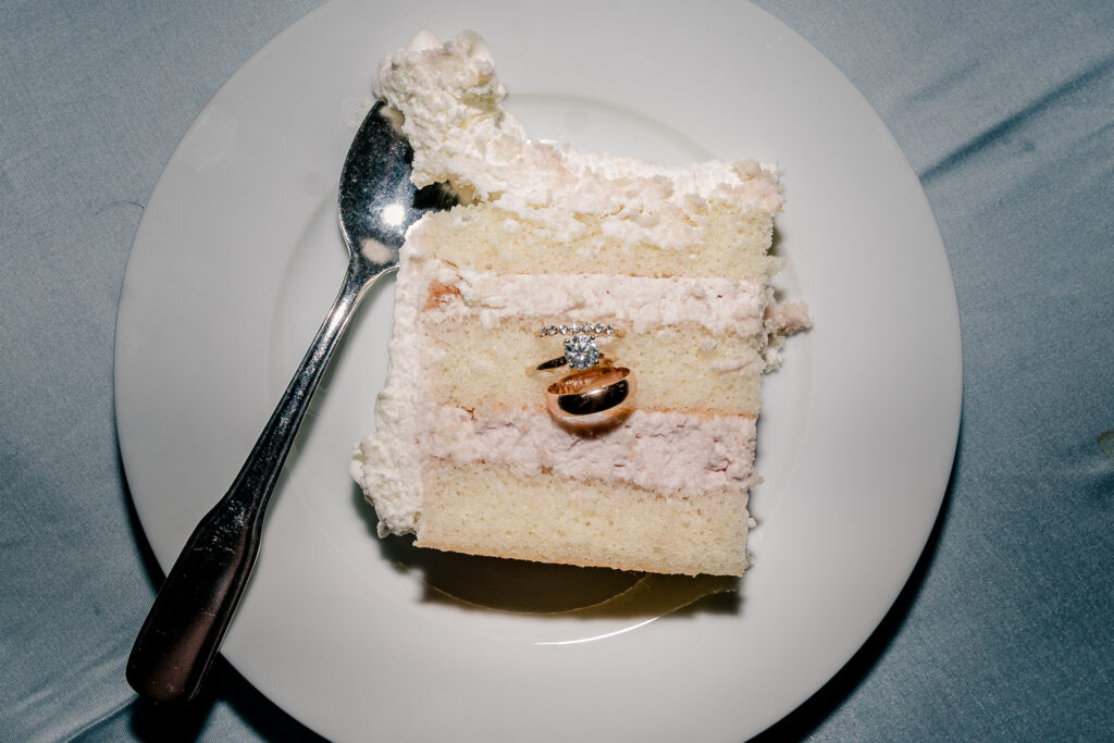 A set of wedding rings inside a slice of cake during a tented wedding reception at Historic Blenheim in Fairfax, Virginia