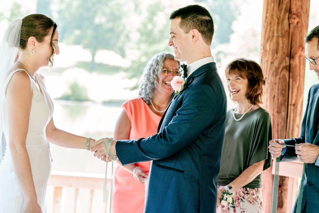 Friends and family laugh during a micro wedding at Meadowlark Botanical Gardens in Vienna, Virginia