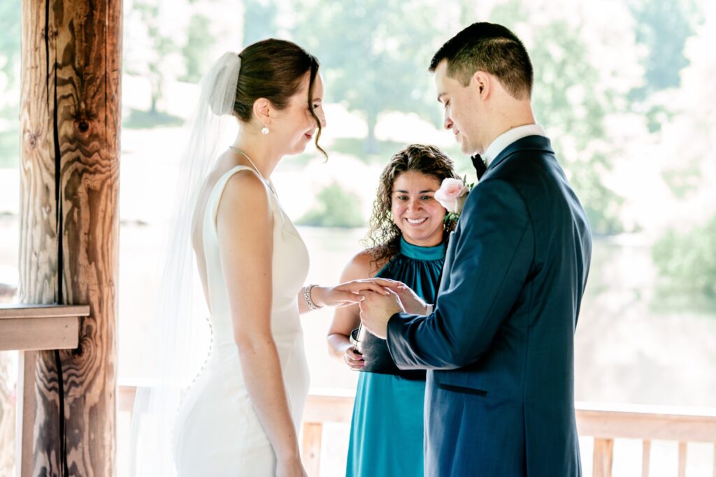 A bride and groom exchange rings during a micro wedding at Meadowlark Botanical Gardens in Vienna, Virginia