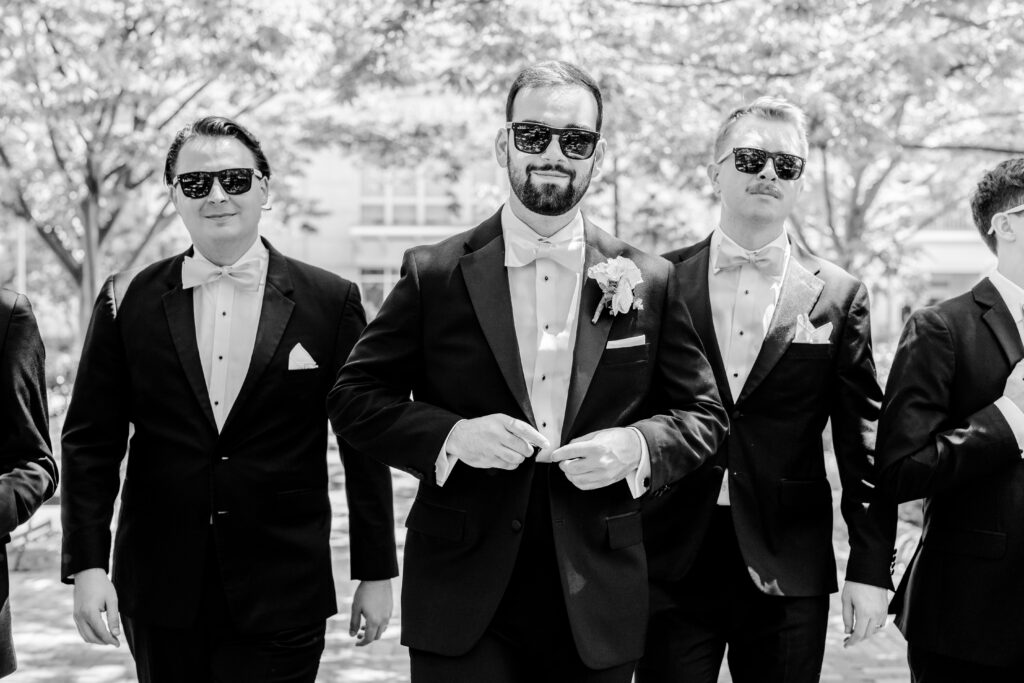 A groom and his groomsmen wearing sunglasses before a Sheraton Reston wedding