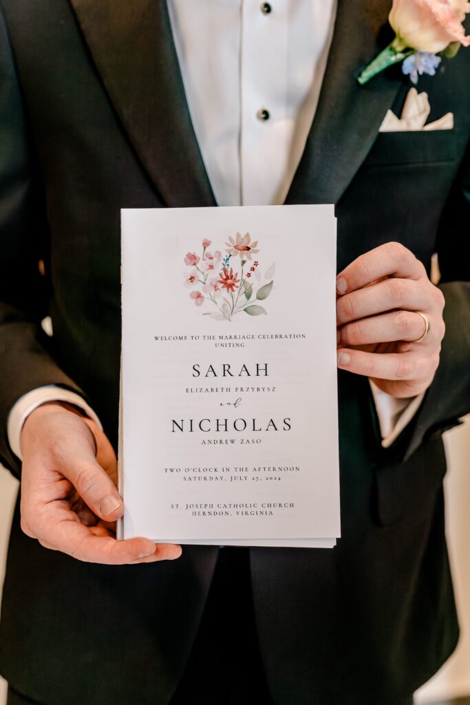 A wedding program held by an usher for a wedding at St. Joseph Catholic Church in Herndon, Virginia