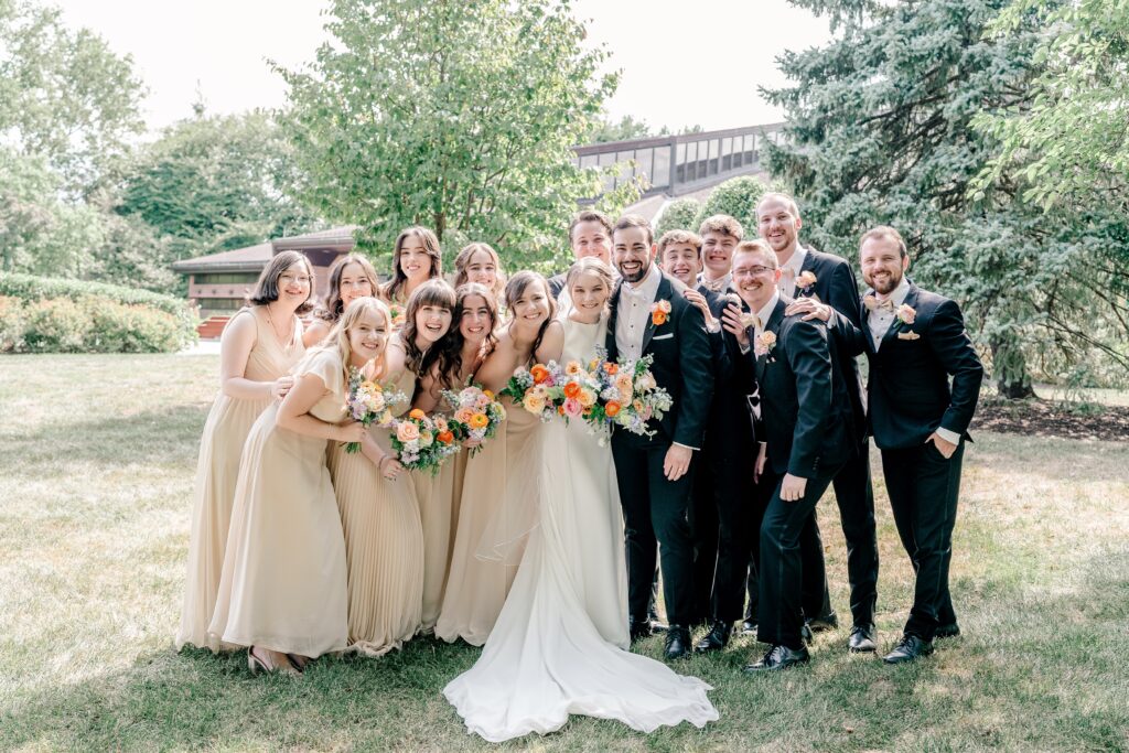 A wedding party gathering for an informal group portrait after a wedding at St. Joseph Catholic Church in Herndon, Virginia