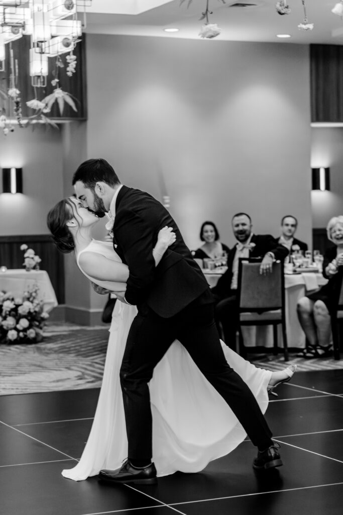 A dramatic dip kiss by the bride and groom during a Sheraton Reston wedding reception