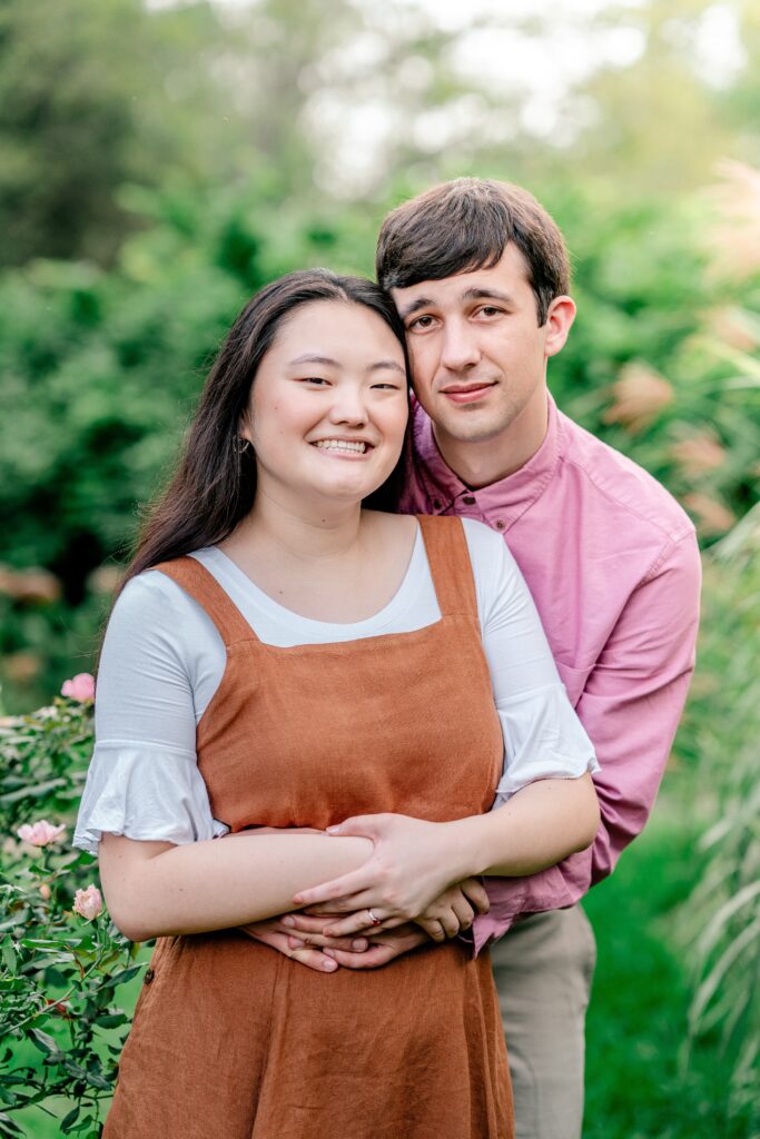 A classic portrait of an engaged couple surrounded by greenery