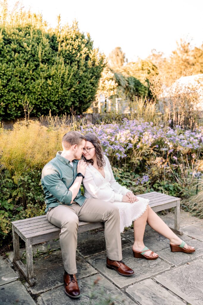 A couple sharing a sweet moment sitting together by Washington DC wedding photographer Beauty of the Soul Studio