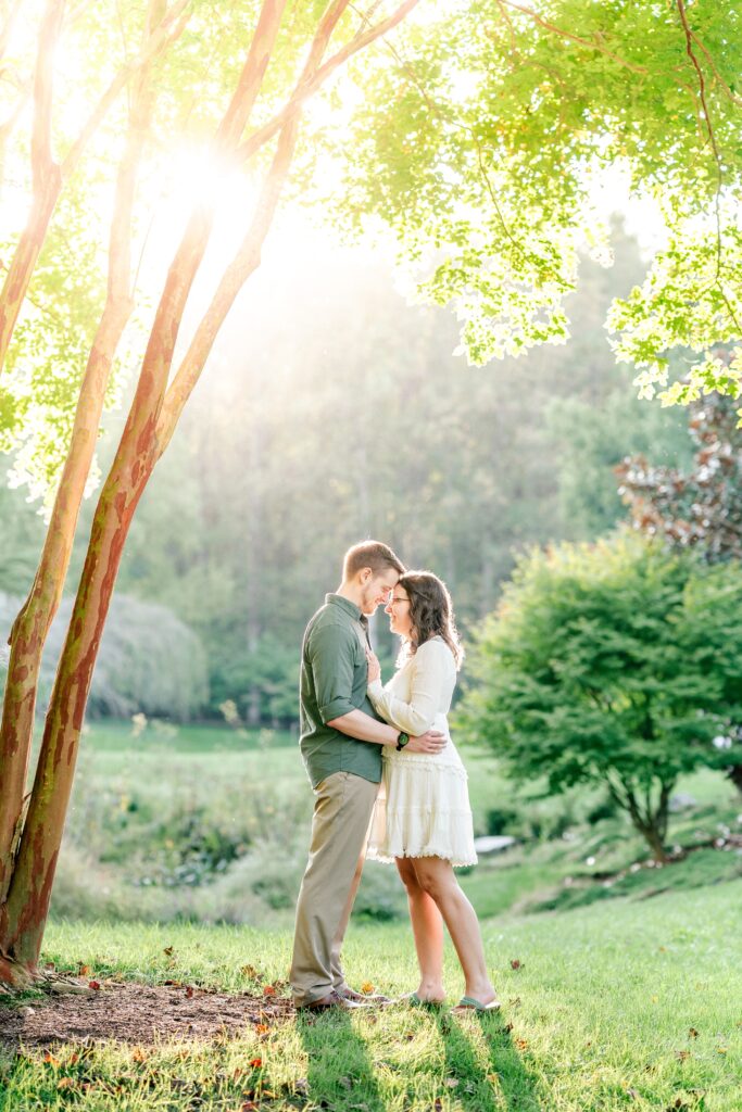 An engaged couple standing in golden hour light by Washington DC wedding photographer Beauty of the Soul Studio