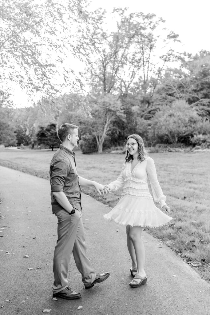 A black and white image of an engaged couple dancing together by Washington DC wedding photographer Beauty of the Soul Studio